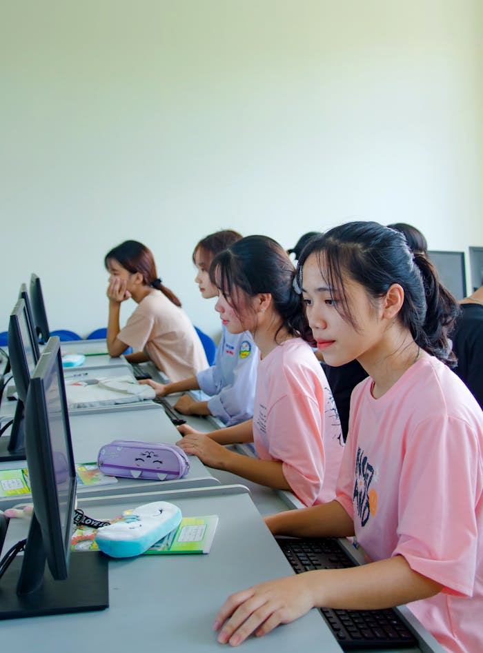 Mastering the First Impression: Your intriguing post title goes here A group of young students focused on computer tasks in a modern classroom setting.