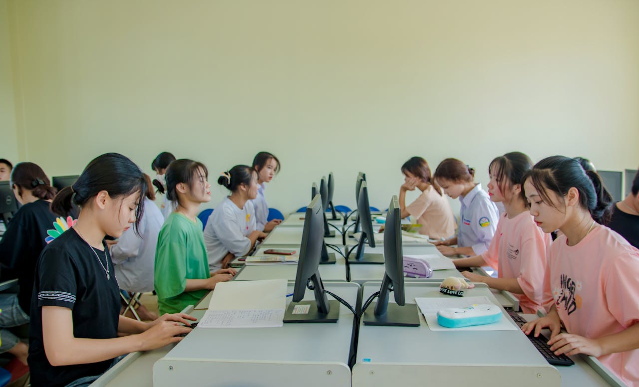 The Art of Drawing Readers In: Your attractive post title goes here Group of female students studying at computers in a classroom setting.